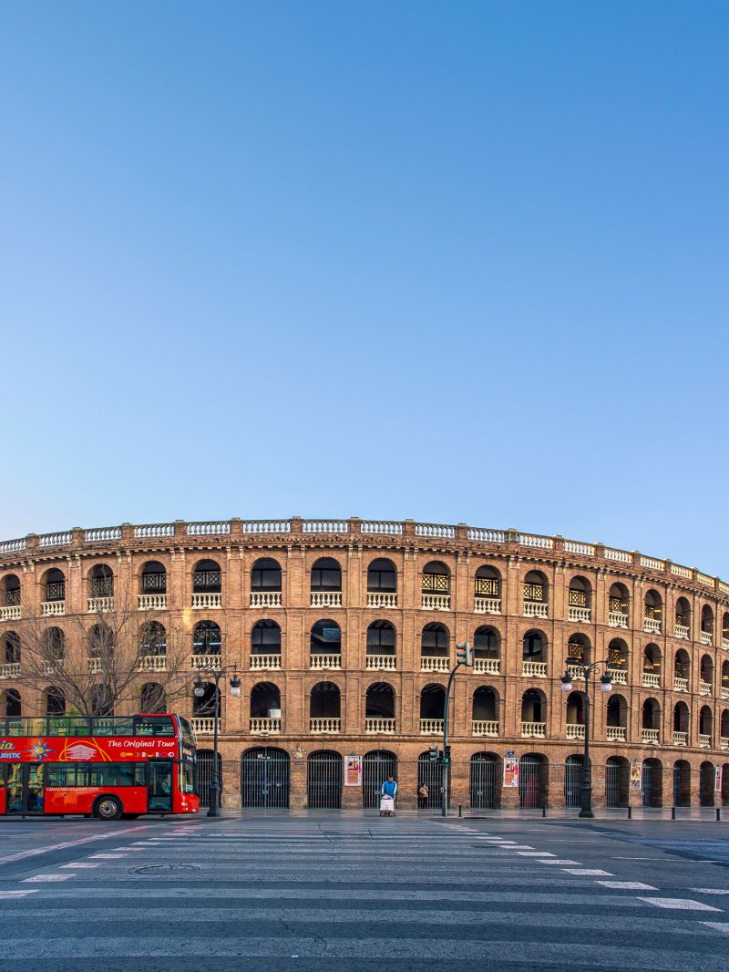 A bus parked in front of Plaza de Toros